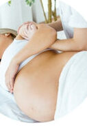 A lady side lying for a pregnancy masage