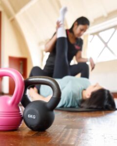 Assisted hamstring stretch with a personal trainer